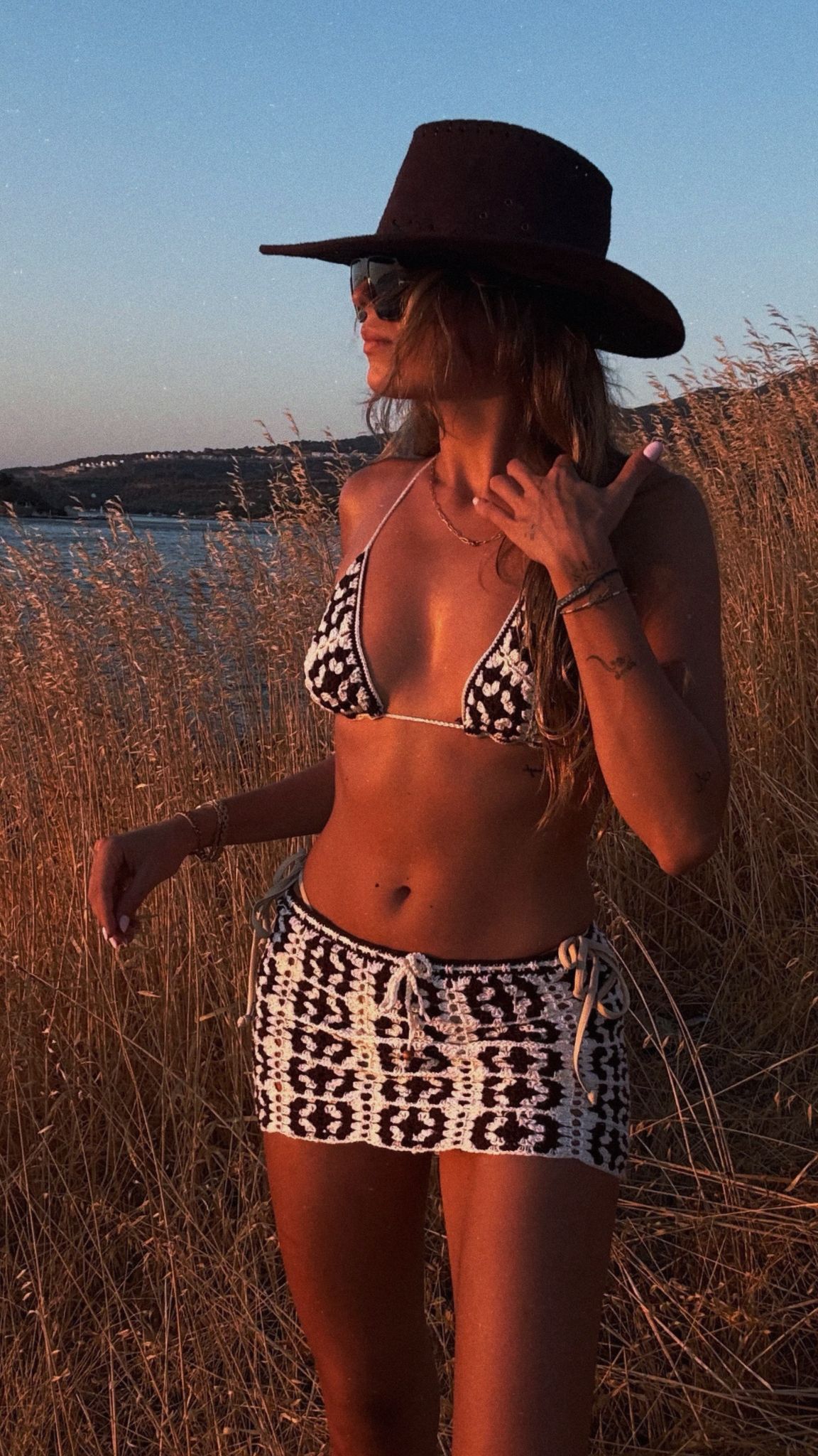 Handmade crochet co-ord set featuring patterned bikini top and skirt, designed for beach-to-party resort style.